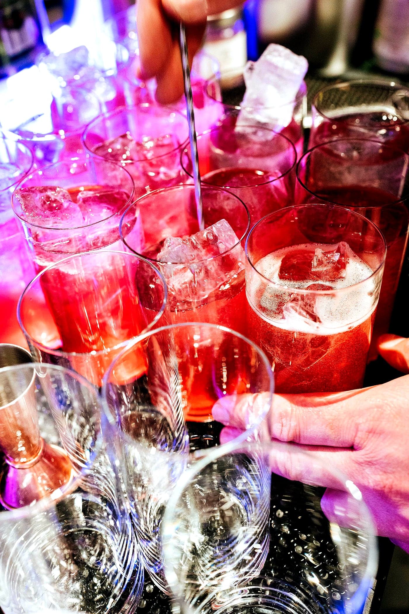 A row of freshly built drinks, backlit